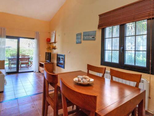 a dining room with a wooden table and chairs at Holiday Home Ducados Golf by Interhome in Pals