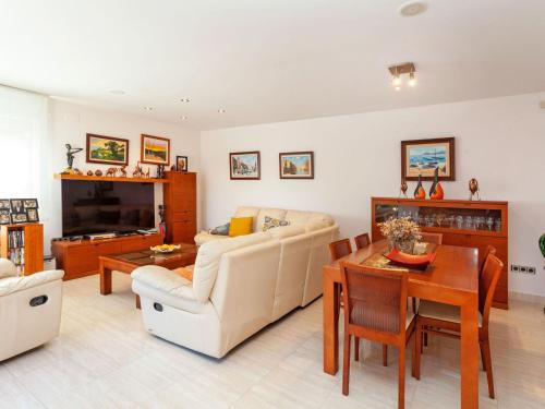 a living room with a couch and a table at Holiday Home Lumiere by Interhome in Sant Antoni de Calonge