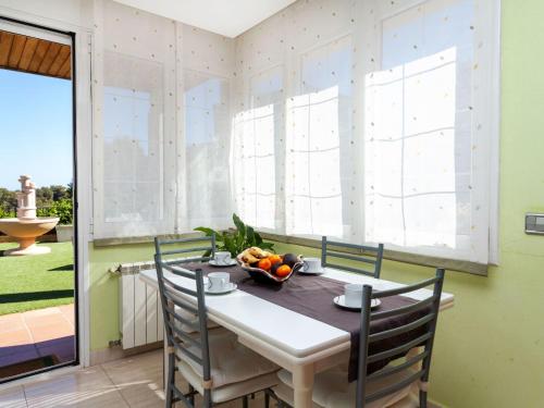 a dining room with a table and chairs at Holiday Home Lumiere by Interhome in Sant Antoni de Calonge