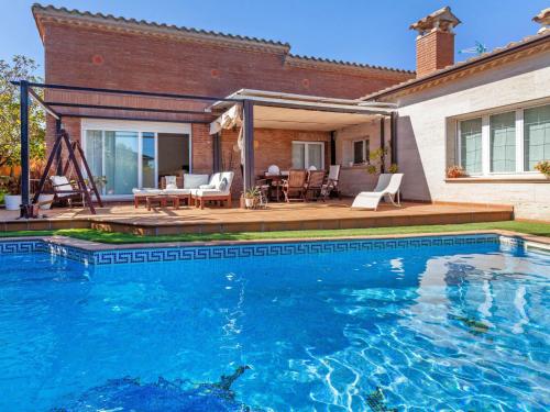 a swimming pool in front of a house at Holiday Home Lumiere by Interhome in Sant Antoni de Calonge