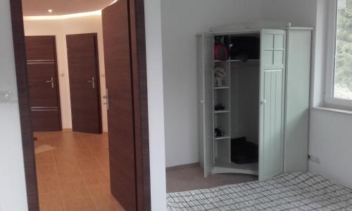 two pictures of a room with a door and a closet at Domek na Mazurach-Piasutno in Piasutno