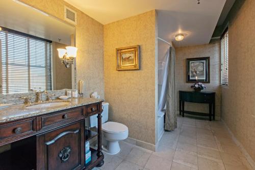 a bathroom with a sink and a toilet and a shower at The Brown Hotel in Louisville