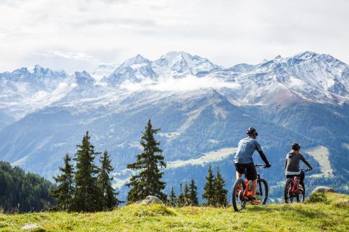a man riding a bike on top of a mountain at Hotel Montpelier in Verbier