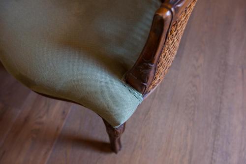 a wooden chair sitting on top of a wooden floor at Porolithos Boutique Hotel in Rhodes Town