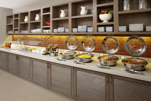 a kitchen with several bowls of food on a counter at Hyatt House Pittsburgh-South Side in Pittsburgh