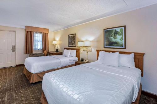 a hotel room with two beds and a window at La Quinta Inn by Wyndham San Antonio I-35 N at Rittiman Rd in San Antonio