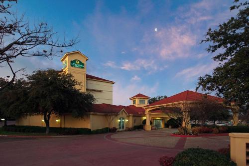 a building with a clock tower on top of it at La Quinta by Wyndham Dallas Arlington South in Arlington