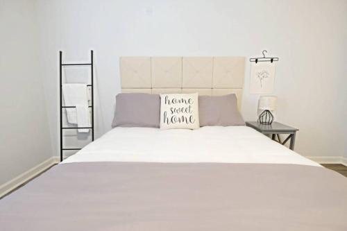 a large white bed with a pillow on it at Dwell Proper 2 Bedroom Condo in Martinez