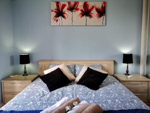 a bedroom with a bed with two night stands and two lamps at Tedy's Townhouse-Margarita Gardens in Paphos City