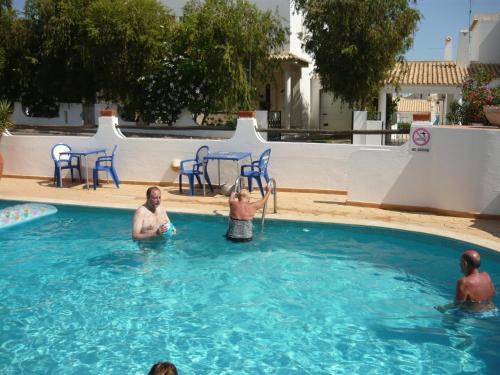 a group of people in a swimming pool at Agua Marinha ROSA- Hotel in Albufeira
