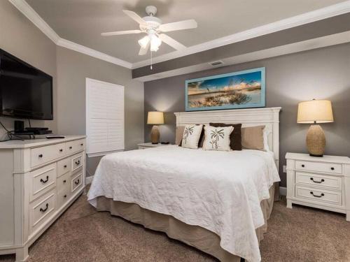 a bedroom with a bed and a flat screen tv at Phoenix On The Bay 2208 by Meyer Vacation Rentals in Orange Beach