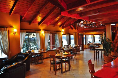 a restaurant with tables and chairs in a room at Charming Luxury Lodge & Private Spa in San Carlos de Bariloche