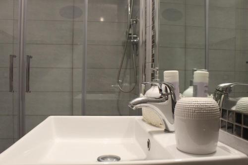 a bathroom sink with a faucet and a mirror at Casa Silvia in Genova