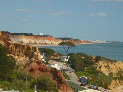 a view of the ocean from a cliff at Agua Marinha ROSA- Hotel in Albufeira