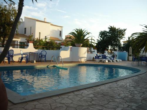 a swimming pool in the middle of a resort at Agua Marinha ROSA- Hotel in Albufeira