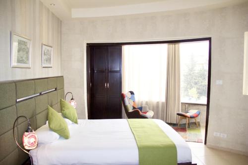 a bedroom with a large bed and a large window at National Hotel - Jerusalem in Jerusalem