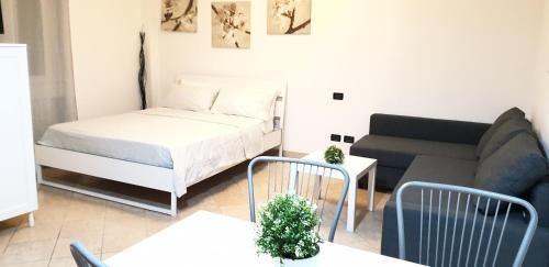 een kleine woonkamer met een bed en een bank bij Philips apartment in Milaan