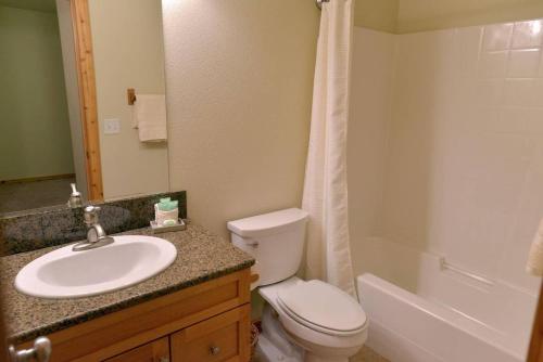 a bathroom with a sink and a toilet and a tub at Mountain Therapy by Casago McCall - Donerightmanagement in McCall