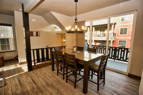 a dining room with a table and chairs on a balcony at Suite Retreat by Casago McCall - Donerightmanagement in McCall