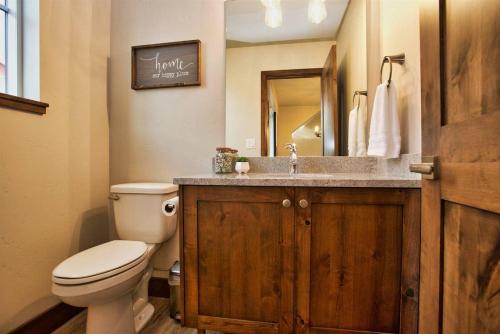 a bathroom with a toilet and a sink with a mirror at Suite Retreat by Casago McCall - Donerightmanagement in McCall
