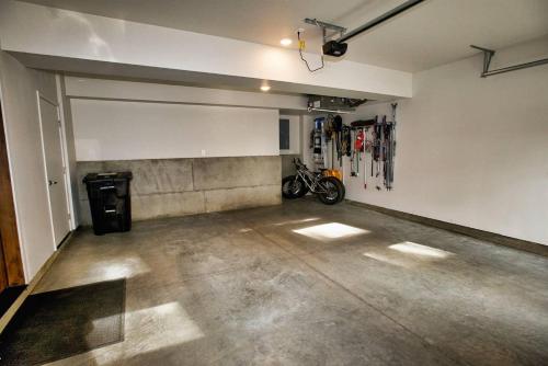 an empty garage with a bike parked in it at Suite Retreat by Casago McCall - Donerightmanagement in McCall