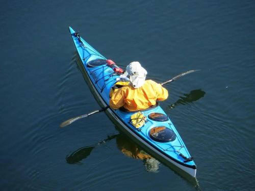 a person in a blue kayak in the water at TimberCrest Downtown Lakeview Condo North by Casago - Donerightmanagement in McCall