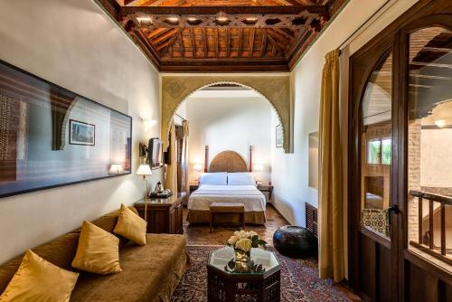 
a large room with a large bed and a large window at Hotel Casa Morisca in Granada
