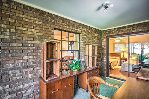 a brick wall in a room with a table and chairs at Lakefront Frostproof Vacation Rental with Beach! in Frostproof