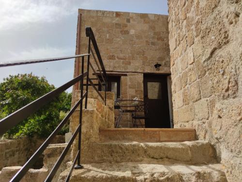 a set of stairs leading up to a stone building at Porolithos Boutique Hotel in Rhodes Town