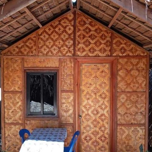 a small room with a door and a window at SHUKRAN Apartelle in Siquijor