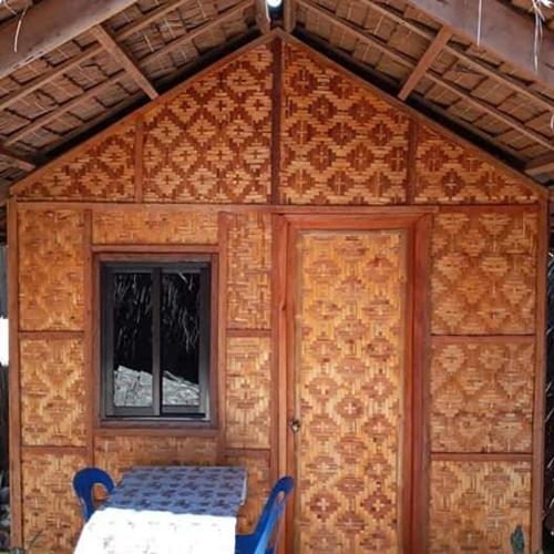 a tiny house with a door and a window at SHUKRAN Apartelle in Siquijor