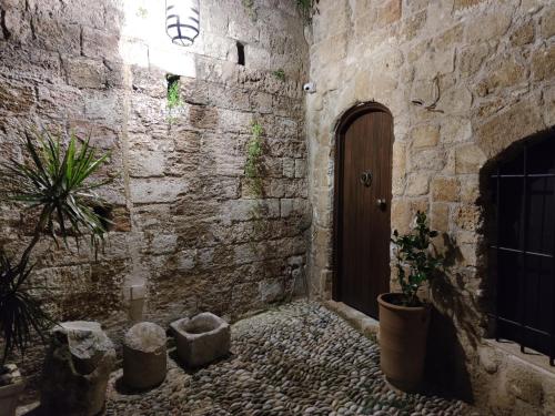 a hallway with a door in a stone wall at Porolithos Boutique Hotel in Rhodes Town