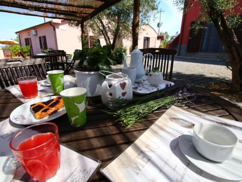 a table with plates of food and drinks on it at Apartment in Montalto near Lake and Pool in Montalto di Castro