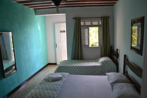 Uma cama ou camas num quarto em Itaoca Pousada Camping