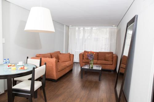 a living room with a couch and a table at Suites Parioli in Mexico City