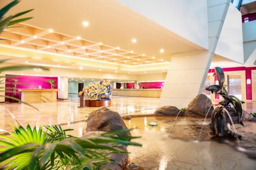 a lobby with a motorcycle in the middle of a room at Crown Paradise Club Cancun - All Inclusive in Cancún
