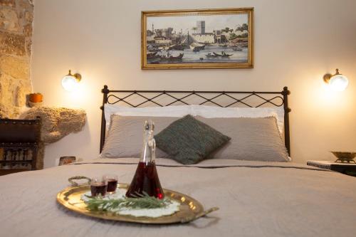 a bed with a tray with drinks on it at Porolithos Boutique Hotel in Rhodes Town