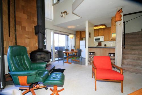 a living room with two chairs and a stove at Sierra Park Villas #24 in Mammoth Lakes