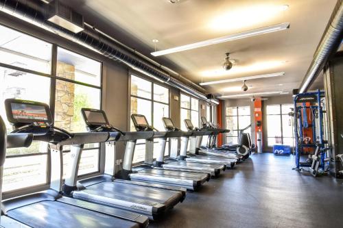 a gym with a row of treadmills at Kasa Legacy Town Center Plano in Plano