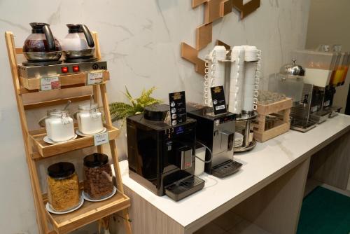 a counter top with a coffee shop with a coffee maker at Altera Hotel and Residence by At Mind in Pattaya Central