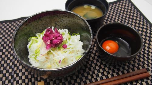 a bowl of rice and vegetables on a table with chopsticks at Hotel Eldia Machida -Adult Only in Kami-seya