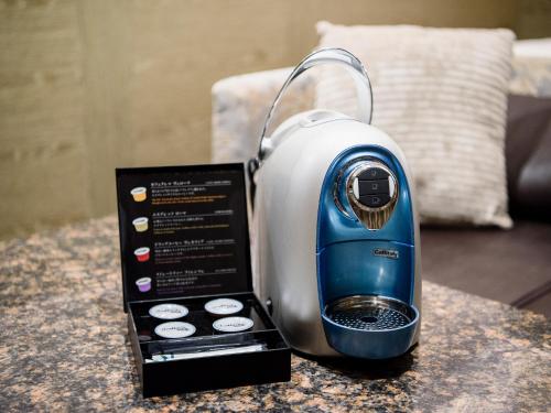 a blue and white toaster sitting on a table at Meguroholic Hotel in Tokyo