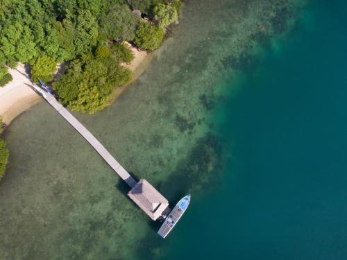 an aerial view of a boat in the water at Plataran Menjangan Resort and Spa - CHSE Certified in Banyuwedang