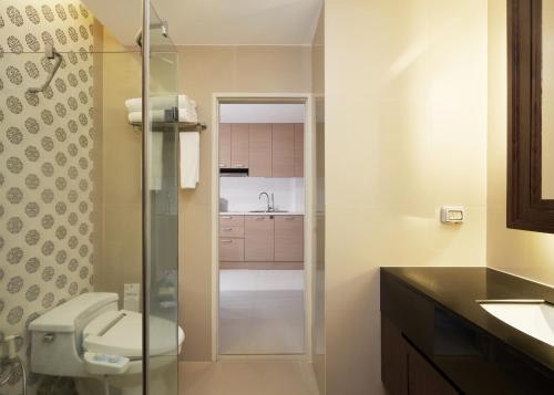 a bathroom with a toilet and a sink at Altera Hotel and Residence by At Mind in Pattaya Central