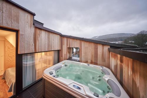 a hot tub on the balcony of a house at Aparthotel Svatý Vavřinec in Pec pod Sněžkou