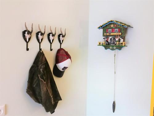 a shelf with antlers and a santa claus hat and a coat at Zur Mühle in Bad Birnbach