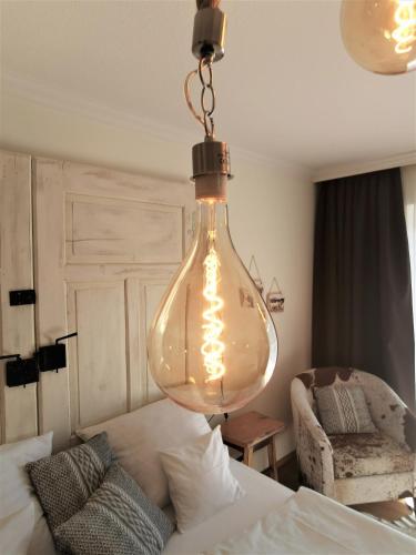 a large glass light bulb hanging from a ceiling at Zur Mühle in Bad Birnbach