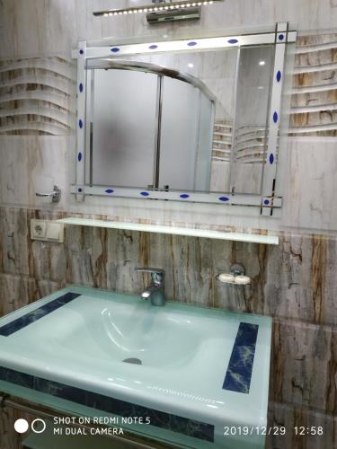 a bathroom with a sink and a mirror at Batumi - Orbi Sea Tower & Residence in Batumi