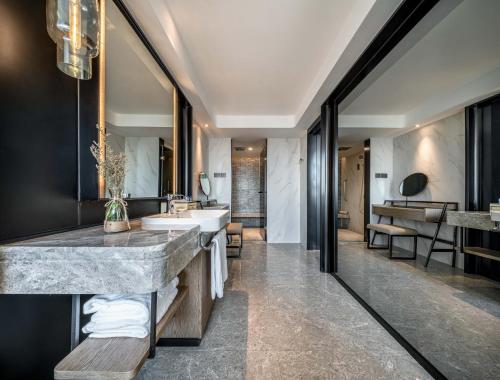 a bathroom with a large marble counter and a sink at Hotel Landmark Canton in Guangzhou