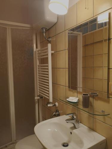 a bathroom with a sink and a mirror at Relais Villa Fiorelli in Rome
